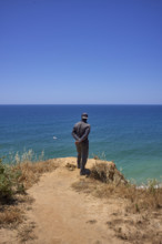 Un homme regarde la mer  en Algarve