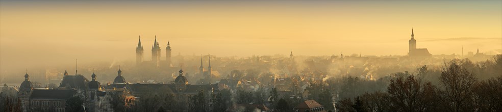 Panorama of the city with early morning mist at sunrise