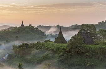 Mist over hills and stupas of Mrauk U at sunrise