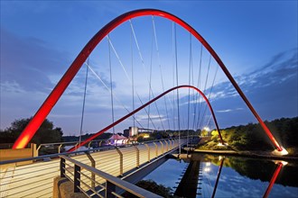 Modern red steel arched bridge over the Rhine-Herne-Canal