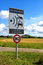 Sign of speed limit reduced to 80 km/hour and radar speed check