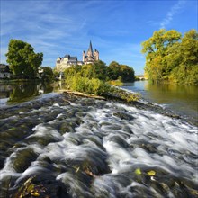 Limburg Cathedral St. Georg or Georgsdom and Limburg Castle over the river Lahn with weir in autumn