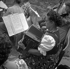 Woman plays accordion after notes