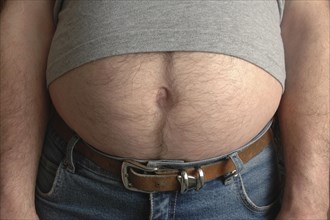 Thick hairy belly looks under a T-shirt