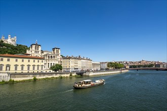 Barge on the Saone river past the cathedral Saint Jean, Lyon
