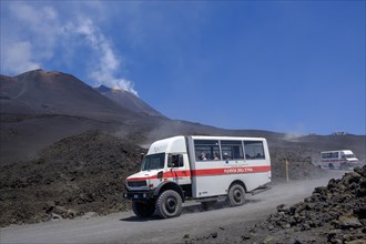 Four-wheel drive vehicles on gravel road to Etna volcano