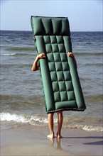 Air mattress with legs on the beach