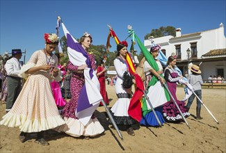 Young women wearing colourful gypsy dresses