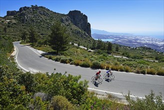 Two racing cyclists on a winding road