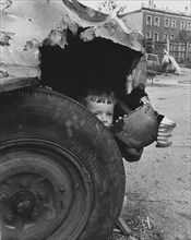 Child in old car