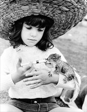 Girl with straw hat feeding chipmunks