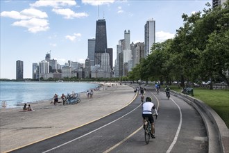 Cyclist on the Lakefront Trail along Lake Shore Drive overlooking the skyline of Chicago