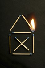 House symbol of matches with a burning match