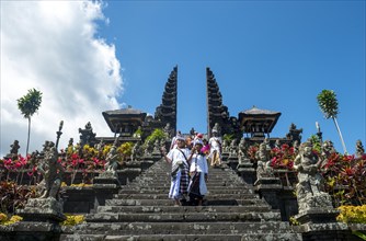 Two Balinese boys go down stairs