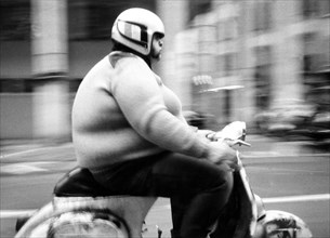 Thick man on a scooter