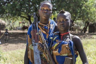 Two young women with Kalashnikovs