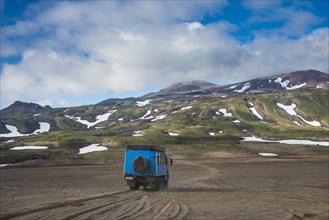 Truck driving through the lava sand