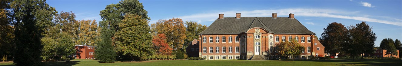 Manor house Borstel Castle with castle park in autumn