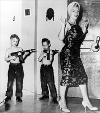 Two boys with rifles against mother