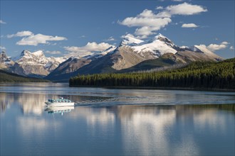 Excursion boat with tourists on Maligne Lake