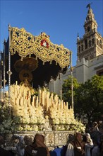 Penitents and decorated float with the Blessed Virgin at the Semana Santa