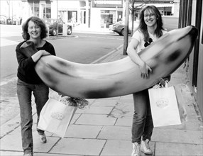 Two women with big banana