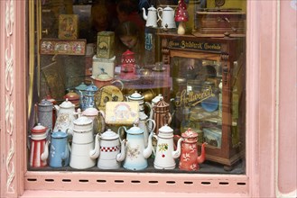Historic coffee pots in shop window of a cafe in Colmar