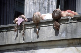 Hair of sunny women hanging down wall