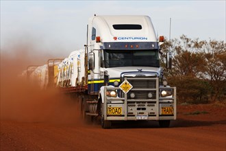 Freightliner road train truck on dusty red outback Australian road