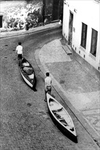 Men transport canoes