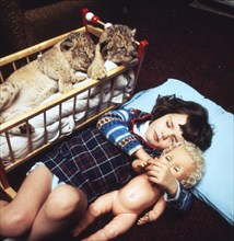 Girls and baby lions sleep