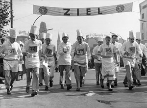 Chefs at the race with cooking pots in hand