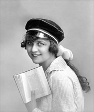 Woman with student hat reading a book