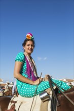 Horsewoman wearing a colourful gypsy dress