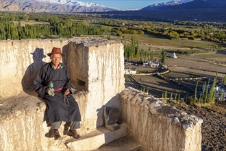 Elderly man taking a rest on a wall