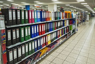 Shelf with office supplies in a supermarket