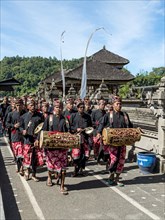 Procession of devout Buddhists with Gamealan musicians at the water temple Pura Ulun Danu Bratan