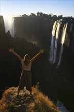 Woman standing in front of Victoria Falls near Livingstone