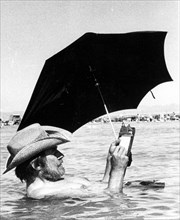 Man with parasol in water