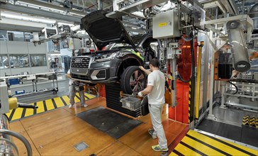 Installation of the wheels on the assembly line for Audi Q2 at the Audi AG plant in Ingolstadt