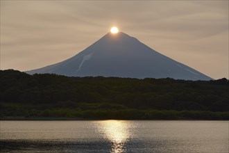 Sunrise over the summit of the Ilyinsky volcano at the Kurilskoye lake