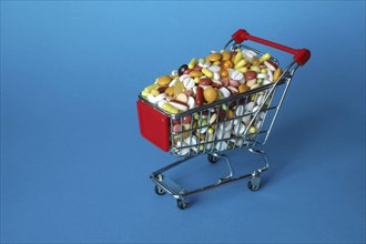 Shopping cart filled with coloured pills