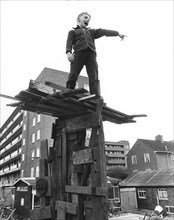 Boy on climbing object made of wood