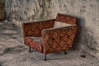 Armchair in destroyed building