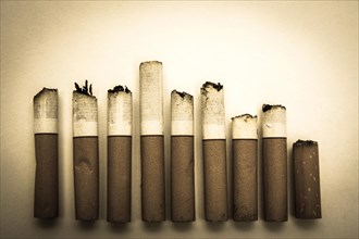 Alignment of nine cigarette butts