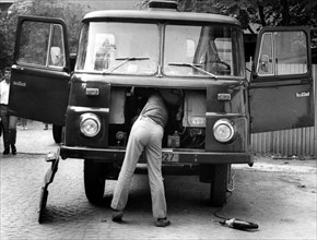 Man repairing trucks ca. 1970s