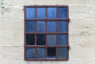Barred window of an old factory building