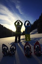 Snowshoe hikers form a heart on the Saukogel