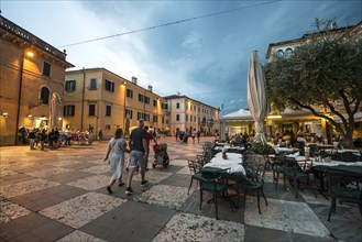 Square with restaurants in the old town in the evening