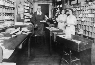 Man and two women working in the post office